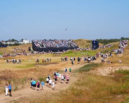 Golf fans walk towards the 13th hole at Royal Birkdale to watch Rory McIlroy practise for the Open