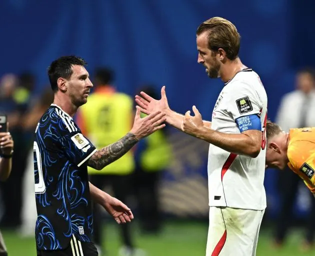 Argentina's Lionel Messi shakes hands with Kane after the match in Atlanta. Photo