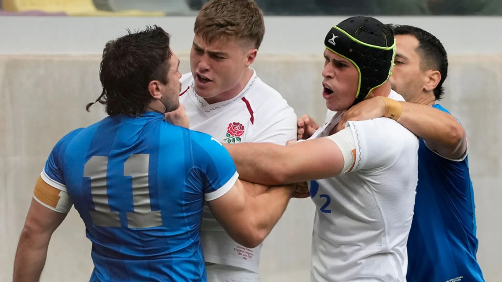 England's Tommy Freeman, center, argues with Argentina's Mateo Carreras (11) during a Nations Championship rugby match in Santiago Del Estero, Argentina, Saturday, July 18, 2026. (AP Photo/Gustavo Garello)
